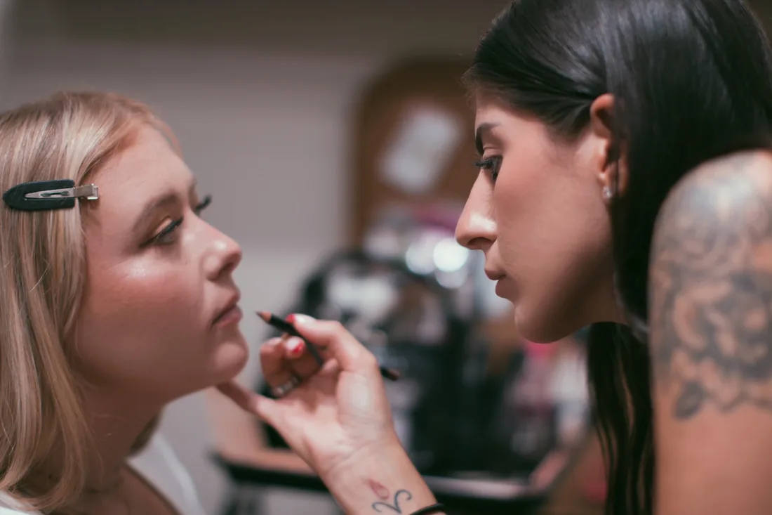 Nicole Jean applying makeup to a bridal client